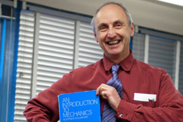 man poses with book titled 