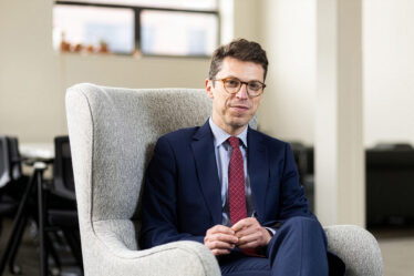 Nuno Loureiro sits in a white chair
