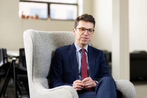 Nuno Loureiro sits in a white chair