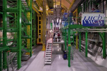 Image of the The LHCb experiment, a large assemblage of metal scaffolding and pipes in bright colors