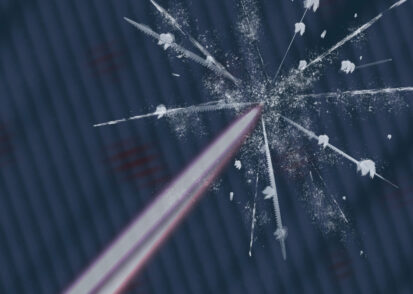 A laser beam hits a surface, causing a glass-like crack with white particles ejected.